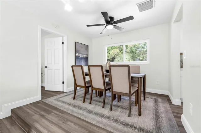 a view of a dining room with furniture and a window