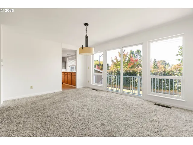 a view of empty room with floor to ceiling windows