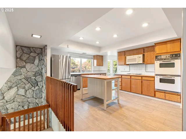 a kitchen with a sink cabinets and wooden floor