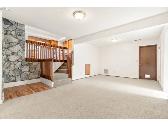 a view of an empty room with stairs