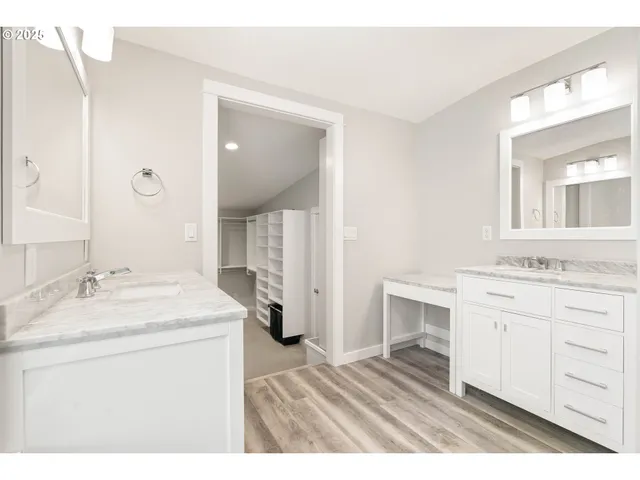 a bathroom with a sink double vanity granite and a mirror