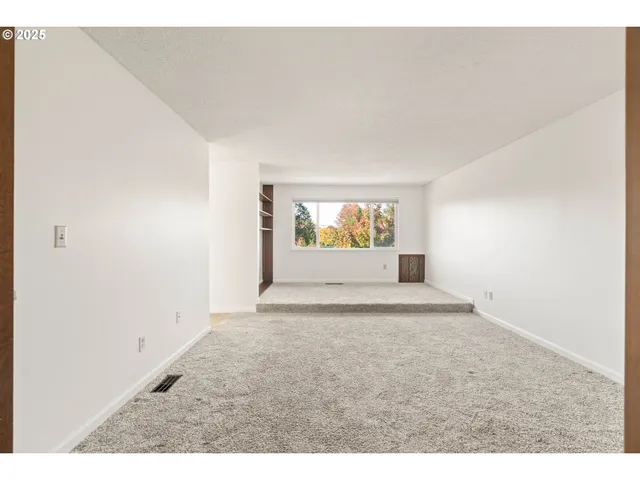 a view of an empty room and a window