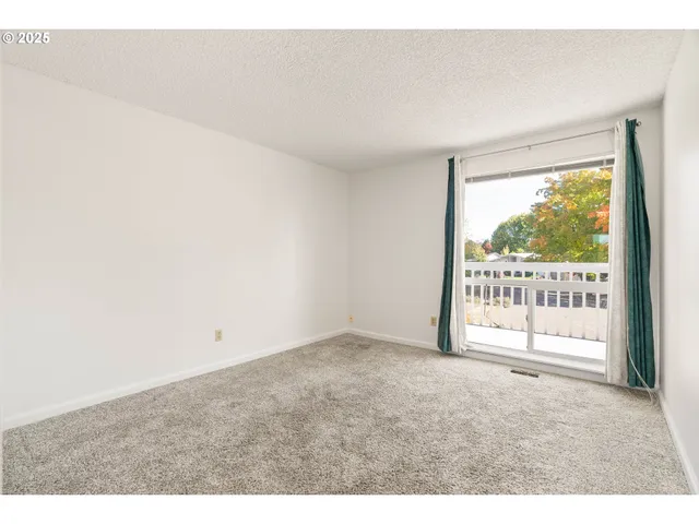 a view of an empty room with a balcony