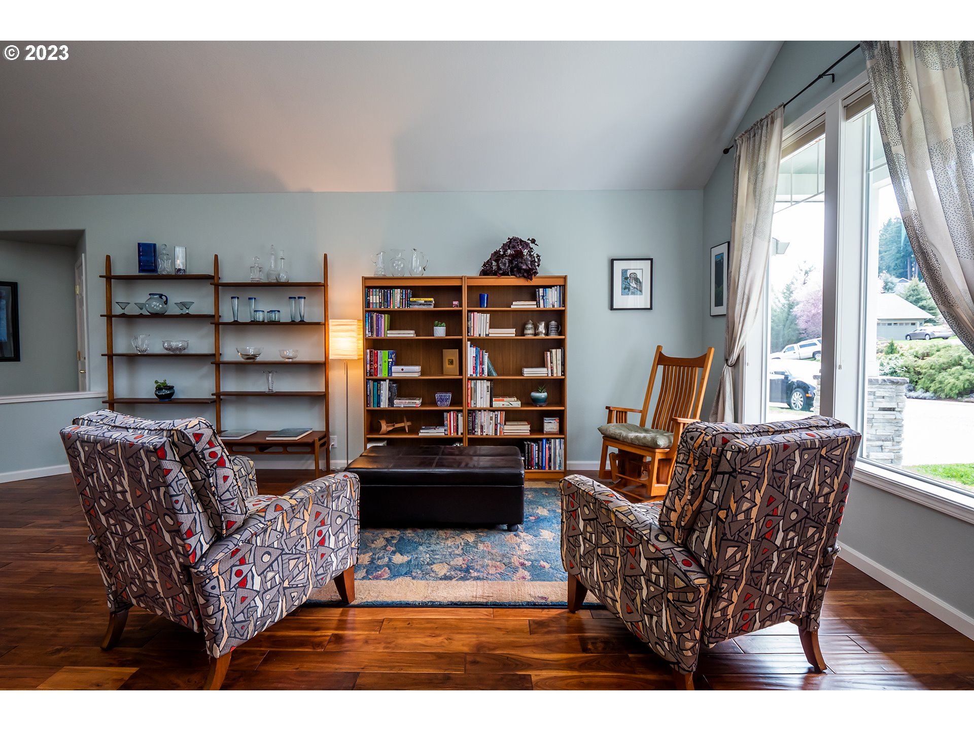 3386 Bentley Avenue Eugene, OR 97405 - Photo 11 of 32 a living room with furniture a flat screen tv and a bookshelf