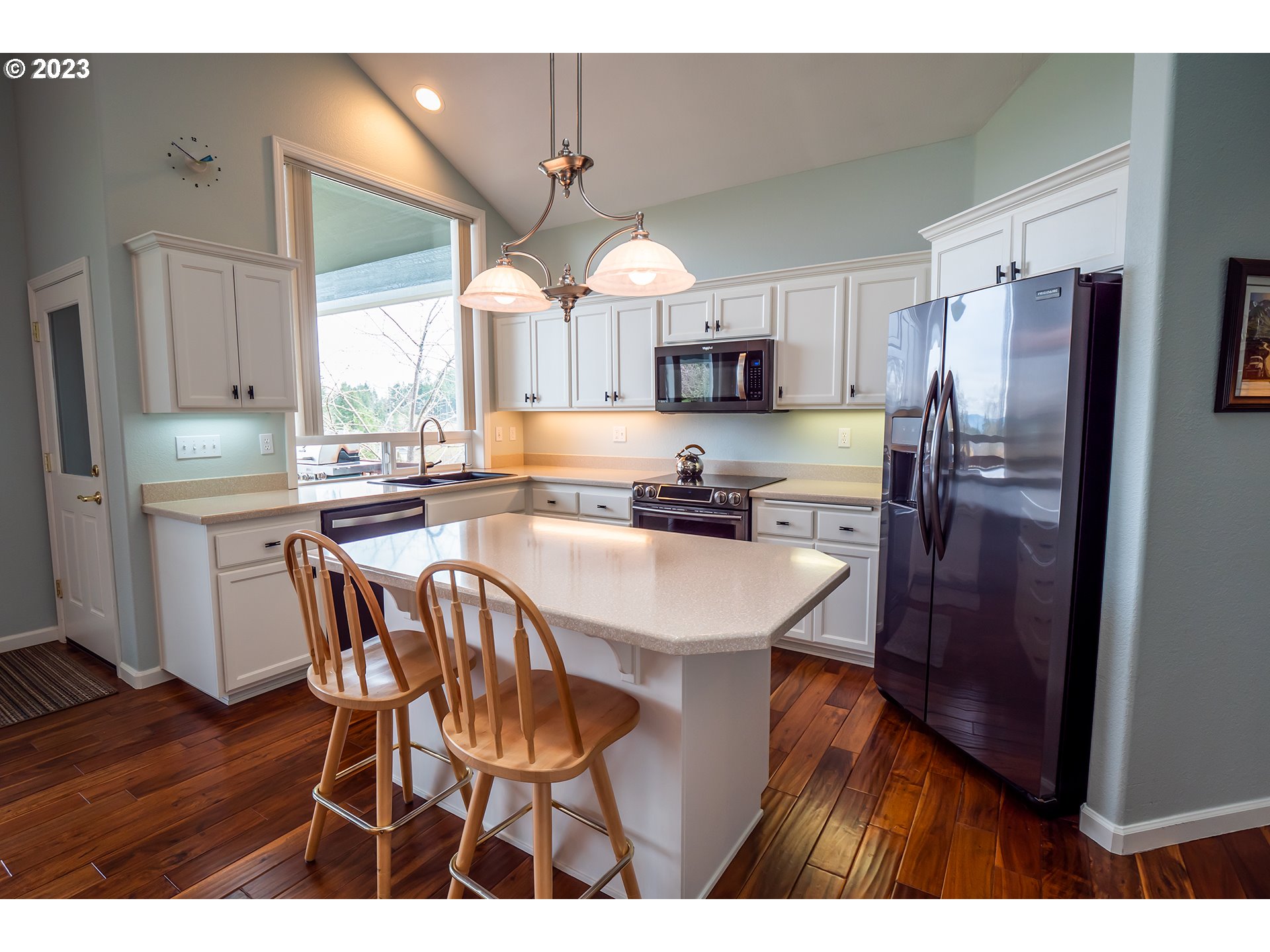 3386 Bentley Avenue Eugene, OR 97405 - Photo 2 of 32 a kitchen with stainless steel appliances a dining table chairs refrigerator and microwave