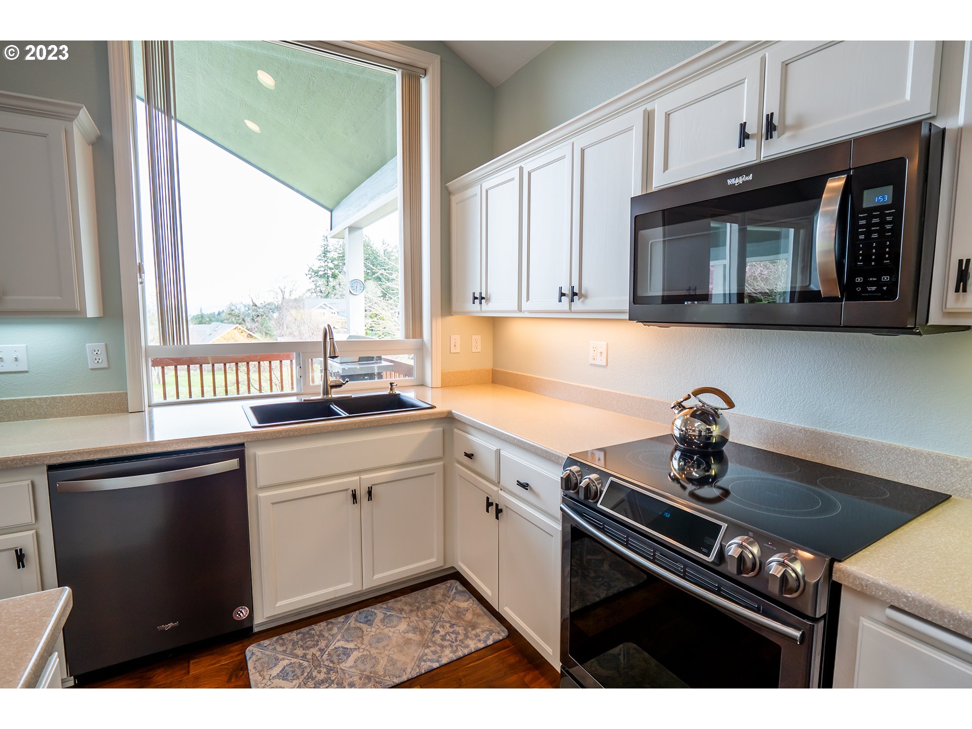 3386 Bentley Avenue Eugene, OR 97405 - Photo 3 of 32 a kitchen with stainless steel appliances a sink stove and cabinets