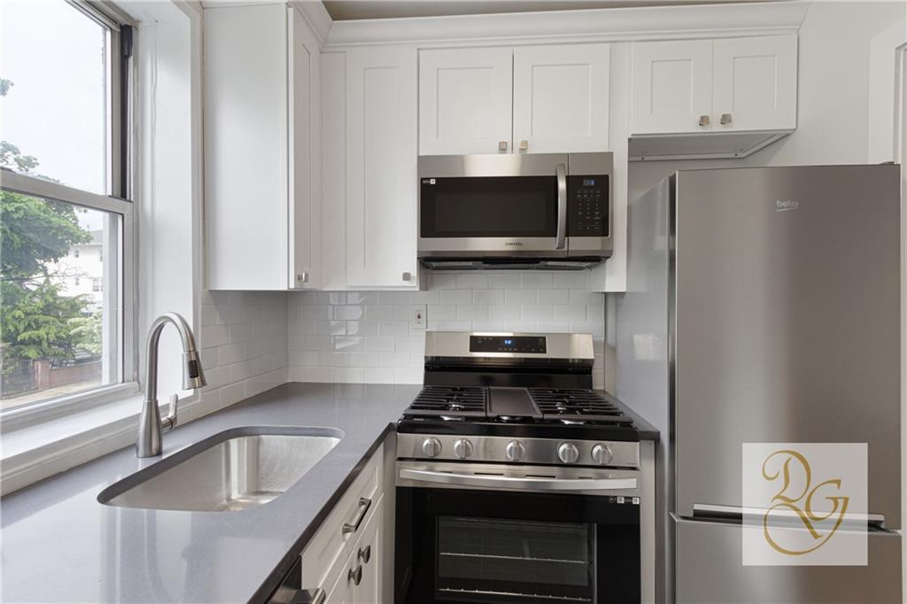 7520 Ridge Boulevard, Unit 1A Brooklyn, NY 11209 - Photo 4 of 18 a kitchen with stainless steel appliances granite countertop a stove a refrigerator and a sink