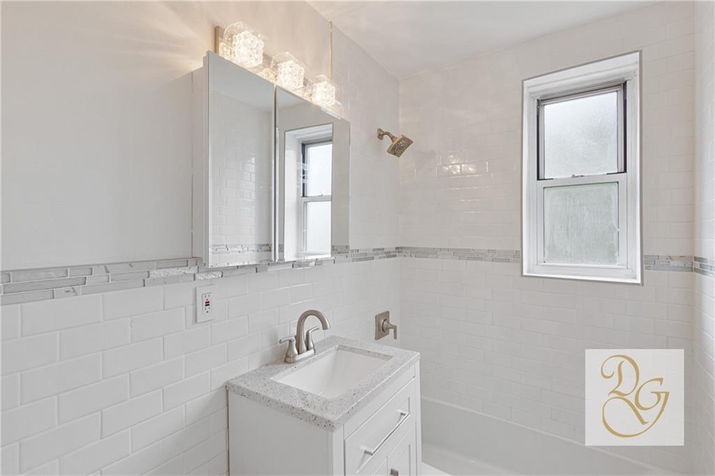 7520 Ridge Boulevard, Unit 1A Brooklyn, NY 11209 - Photo 6 of 18 a bathroom with a sink a toilet and mirror
