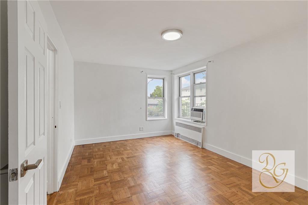 7520 Ridge Boulevard, Unit 1A Brooklyn, NY 11209 - Photo 10 of 18 a view of empty room with wooden floor and fan