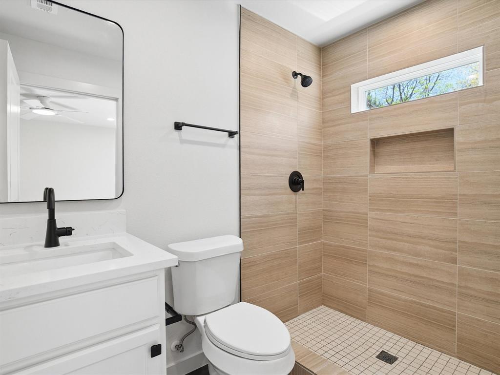 5544 Ranchero Lane Dallas, TX 75236 - Photo 11 of 21 a bathroom with a toilet sink and shower