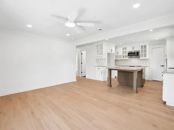 a view of kitchen with cabinets and wooden floor