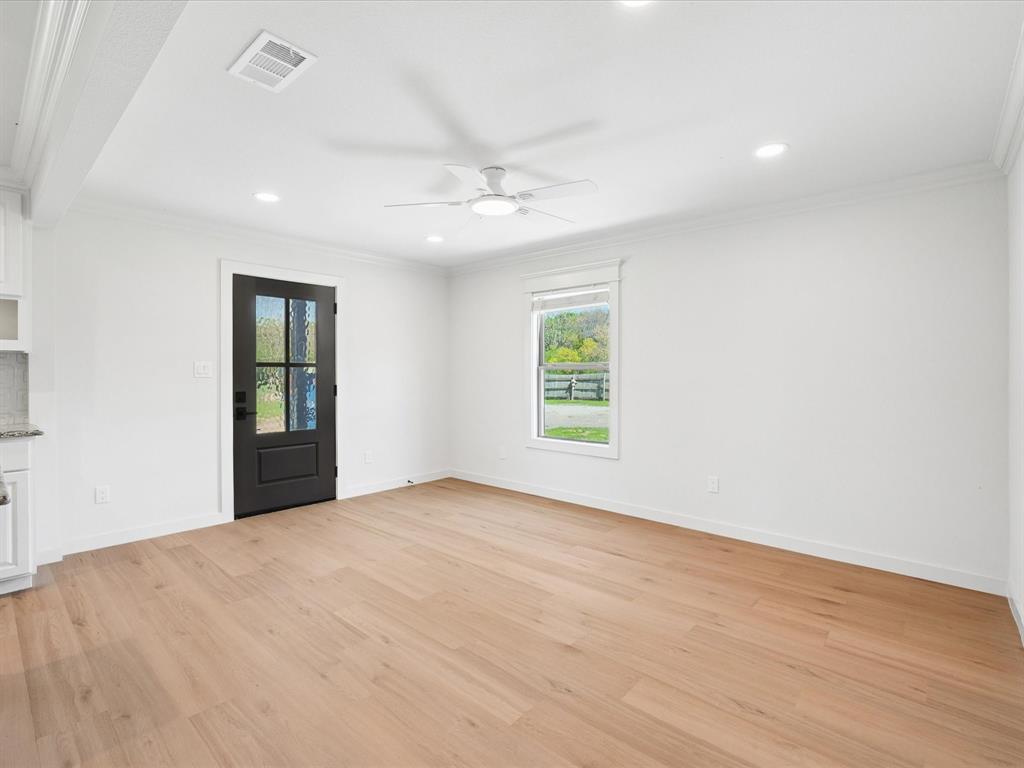 5544 Ranchero Lane Dallas, TX 75236 - Photo 5 of 21 an empty room with windows and ceiling fan