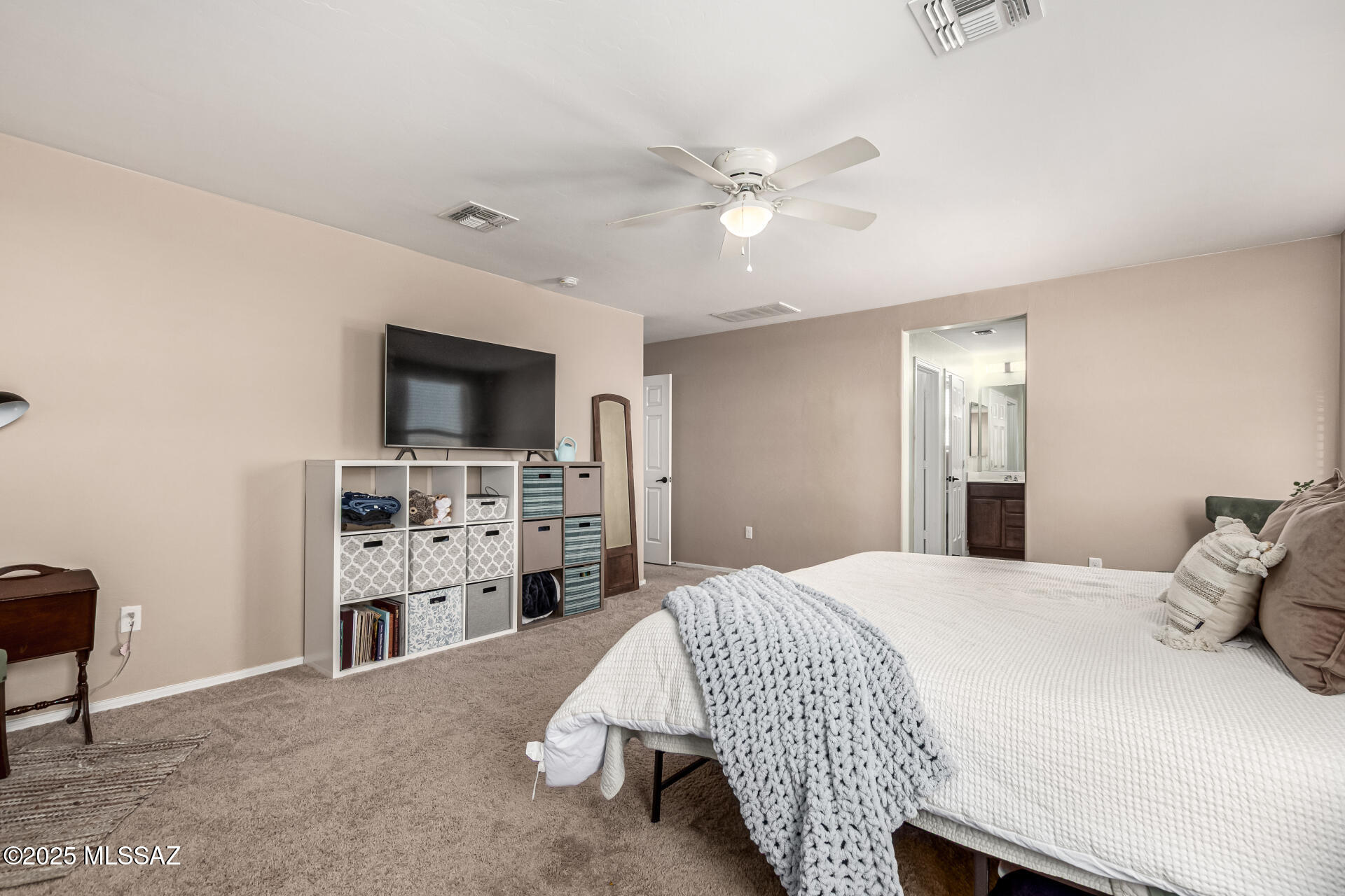 9528 Desert Fauna Loop Tucson, AZ 85747 - Photo 25 of 46 a bedroom with a bed and a television
