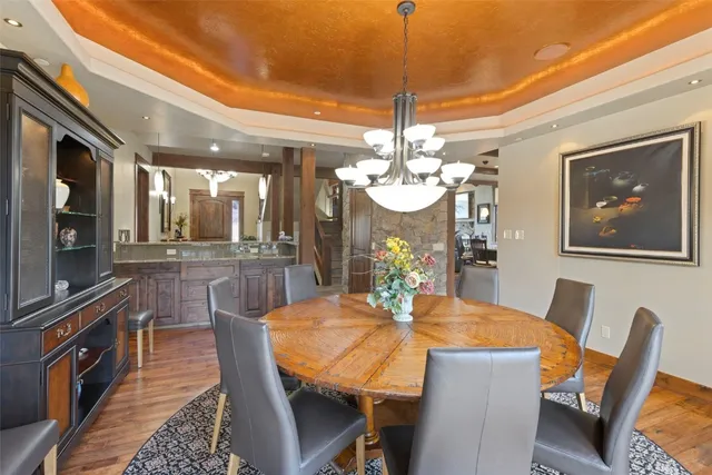 a bedroom with a large bed and a chandelier