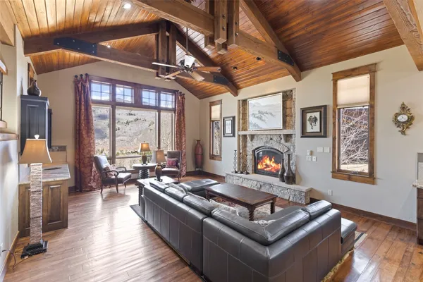 a living room with furniture fireplace and a large window