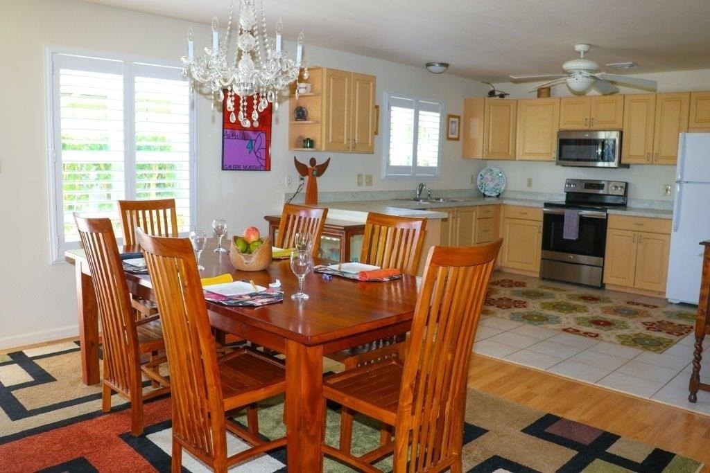 6671 Puupilo Road Kapaa, HI 96746 - Photo 11 of 24 a view of a dining room with furniture a chandelier and wooden floor