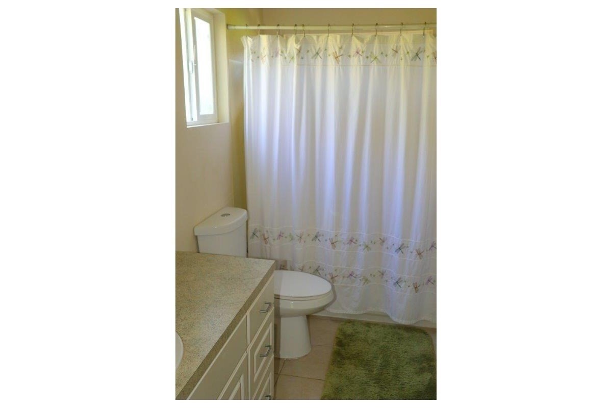 6671 Puupilo Road Kapaa, HI 96746 - Photo 14 of 24 a bathroom with a toilet a sink and a mirror