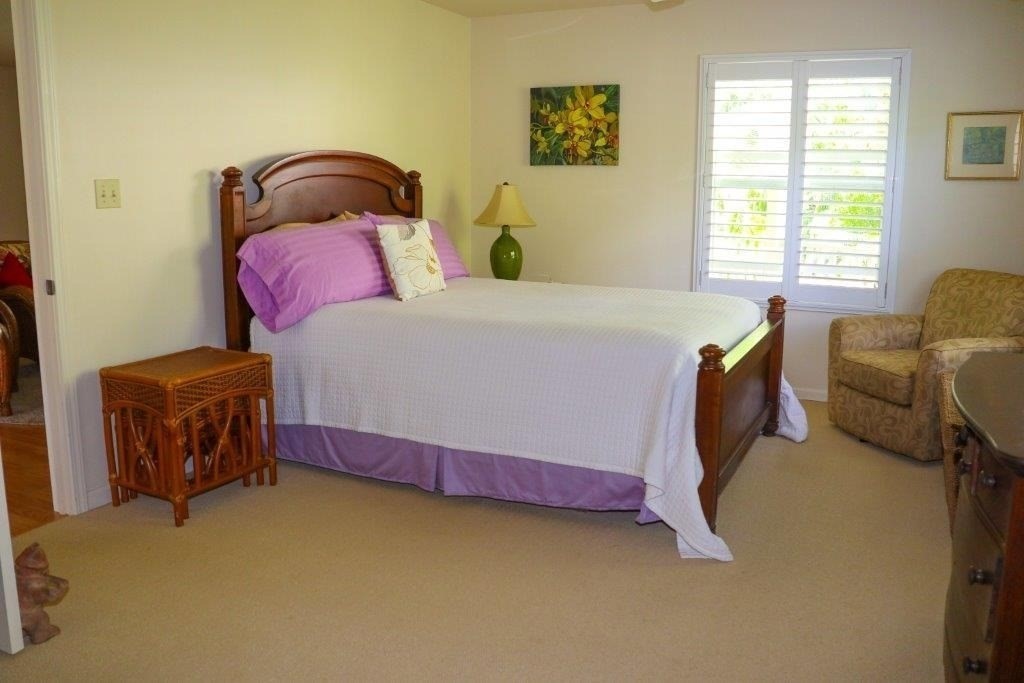 6671 Puupilo Road Kapaa, HI 96746 - Photo 16 of 24 a bedroom with a bed and wooden floor