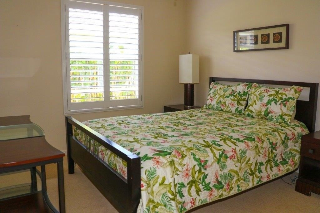 6671 Puupilo Road Kapaa, HI 96746 - Photo 18 of 24 a bed sitting in a bedroom next to a window