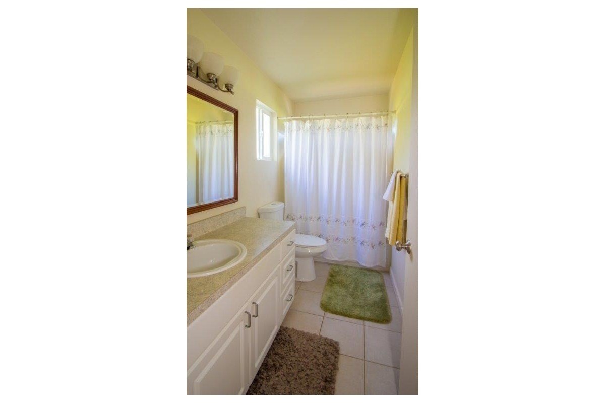 6671 Puupilo Road Kapaa, HI 96746 - Photo 23 of 24 a bathroom with a granite countertop sink and a bathtub