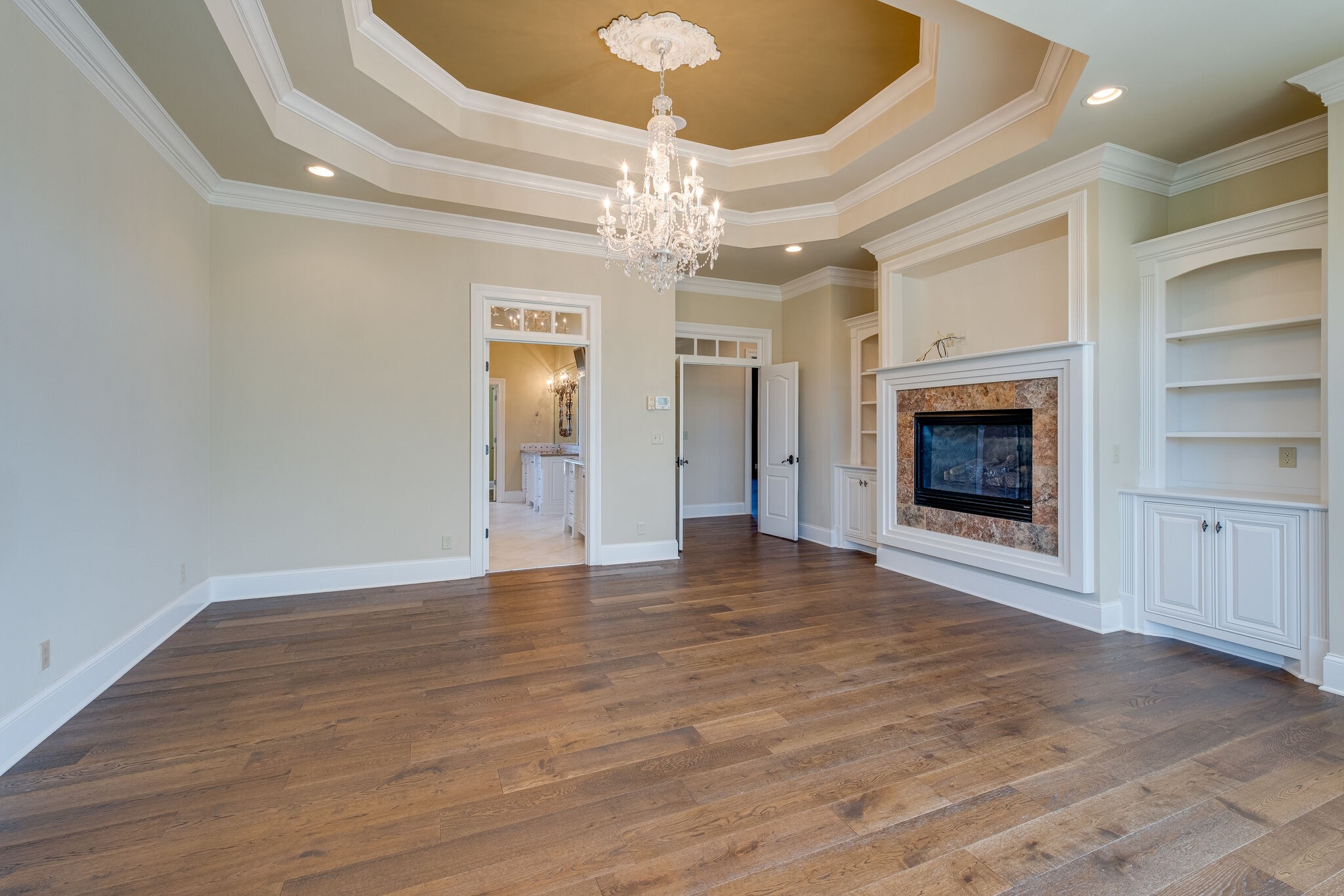 1800 Horn Springs Road Lebanon, TN 37087 - Photo 24 of 56 an empty room with wooden floor fireplace chandelier and windows