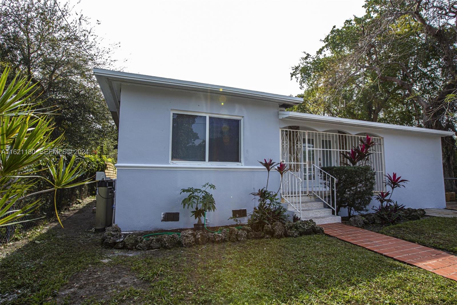 418 Northwest 47th Street Miami, FL 33127 - Photo 11 of 24 a front view of house with yard and outdoor seating