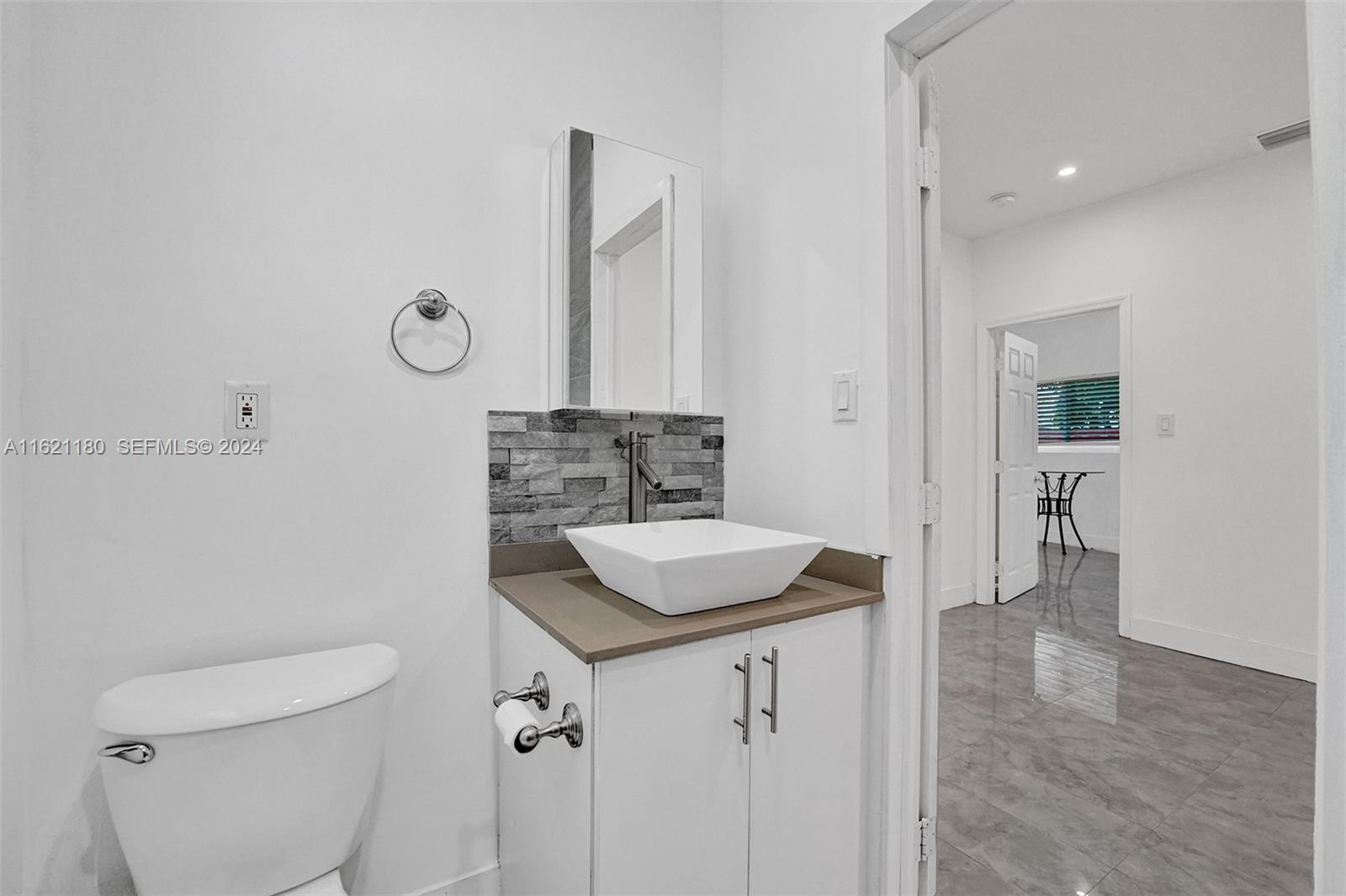 418 Northwest 47th Street Miami, FL 33127 - Photo 17 of 24 a bathroom with a sink toilet vanity and tub