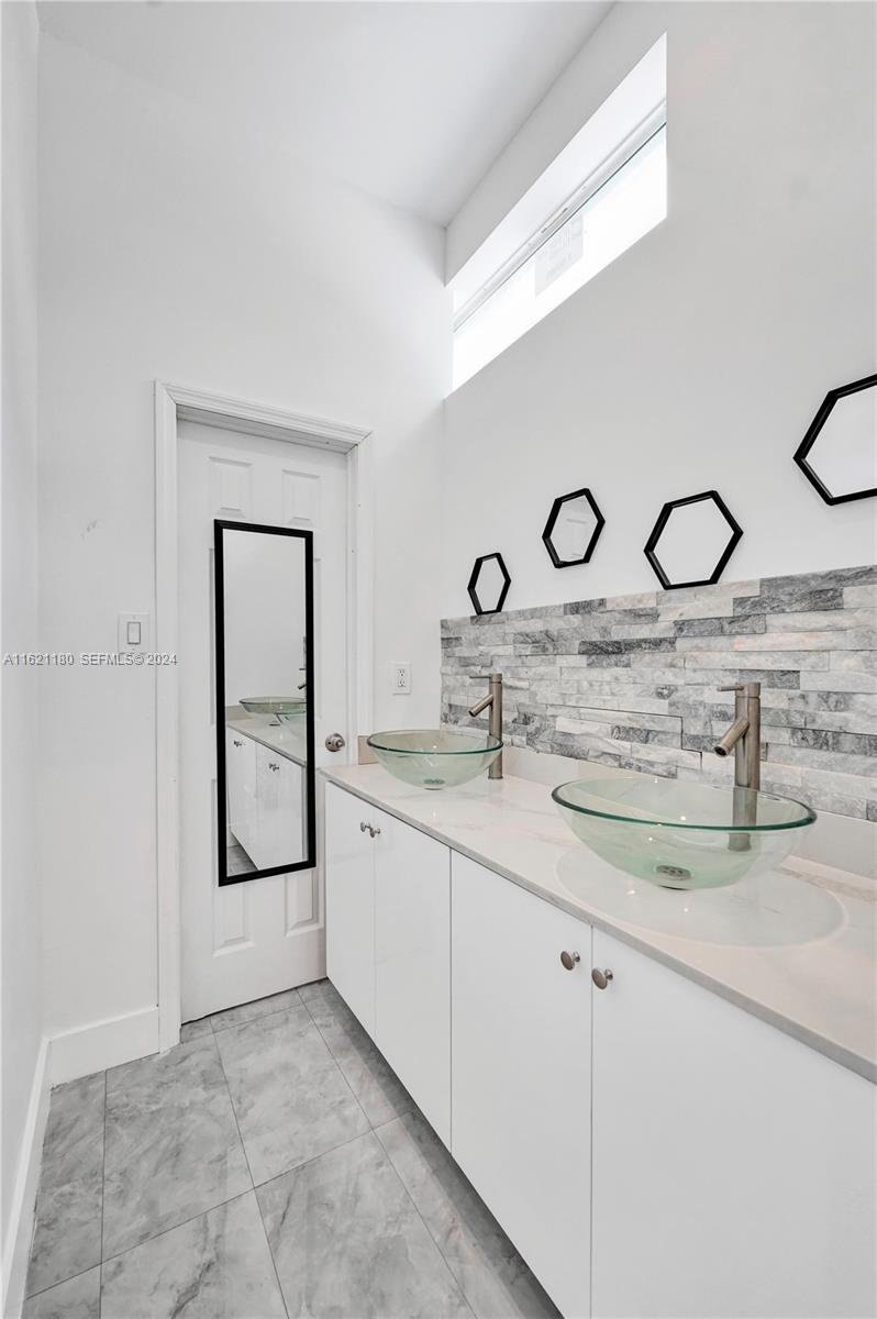 418 Northwest 47th Street Miami, FL 33127 - Photo 21 of 24 a bathroom with sink and mirror