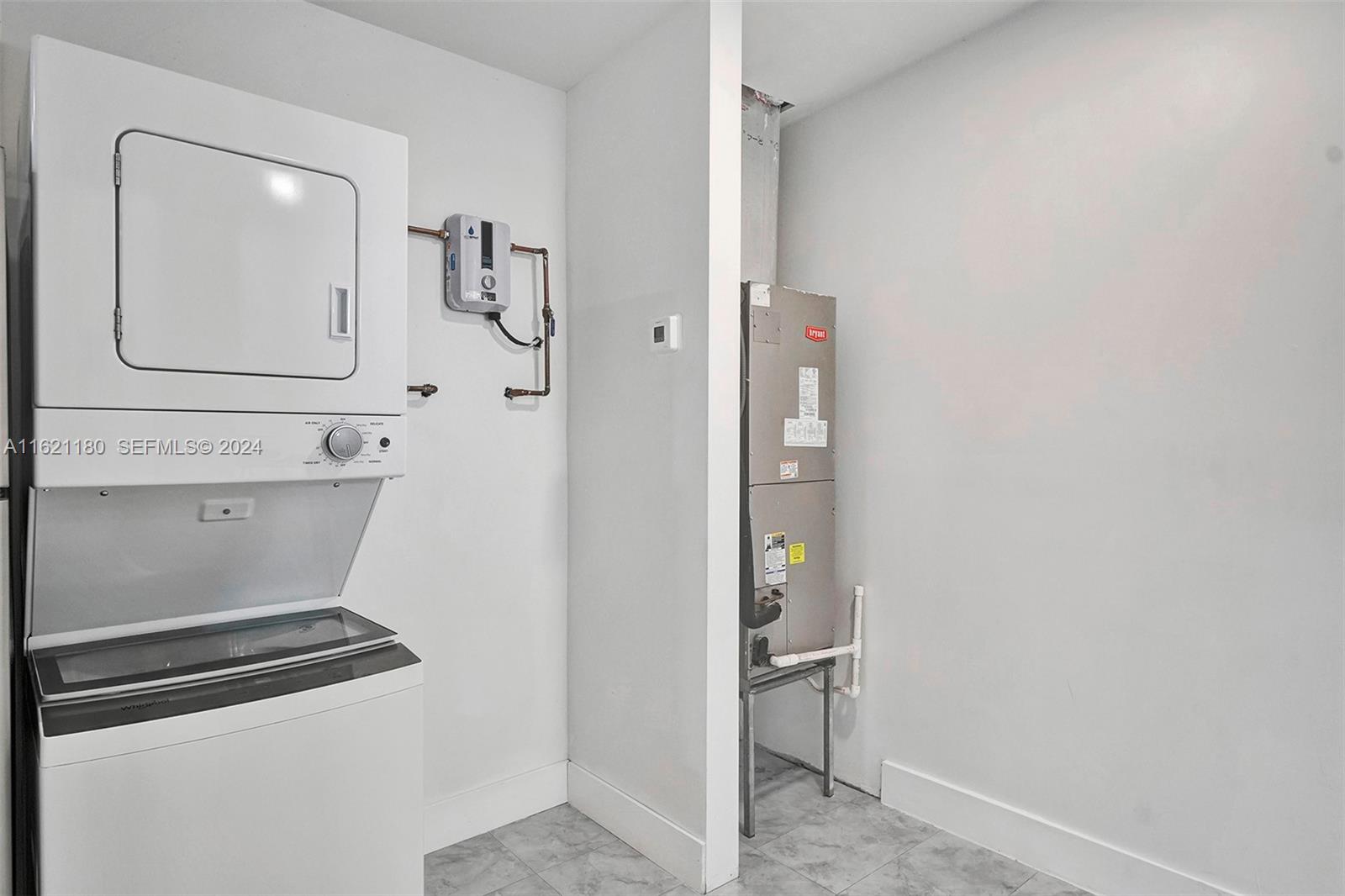 418 Northwest 47th Street Miami, FL 33127 - Photo 22 of 24 a bathroom with a mirror and a shower