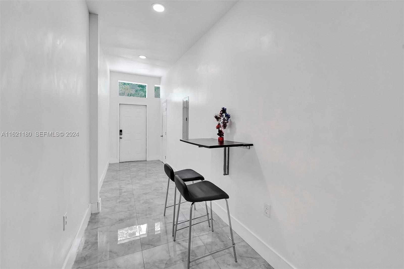 418 Northwest 47th Street Miami, FL 33127 - Photo 23 of 24 a living room with furniture and a ceiling fan