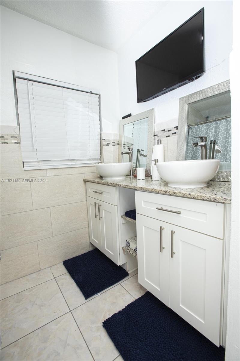 418 Northwest 47th Street Miami, FL 33127 - Photo 6 of 24 a kitchen with a sink a stove and cabinets