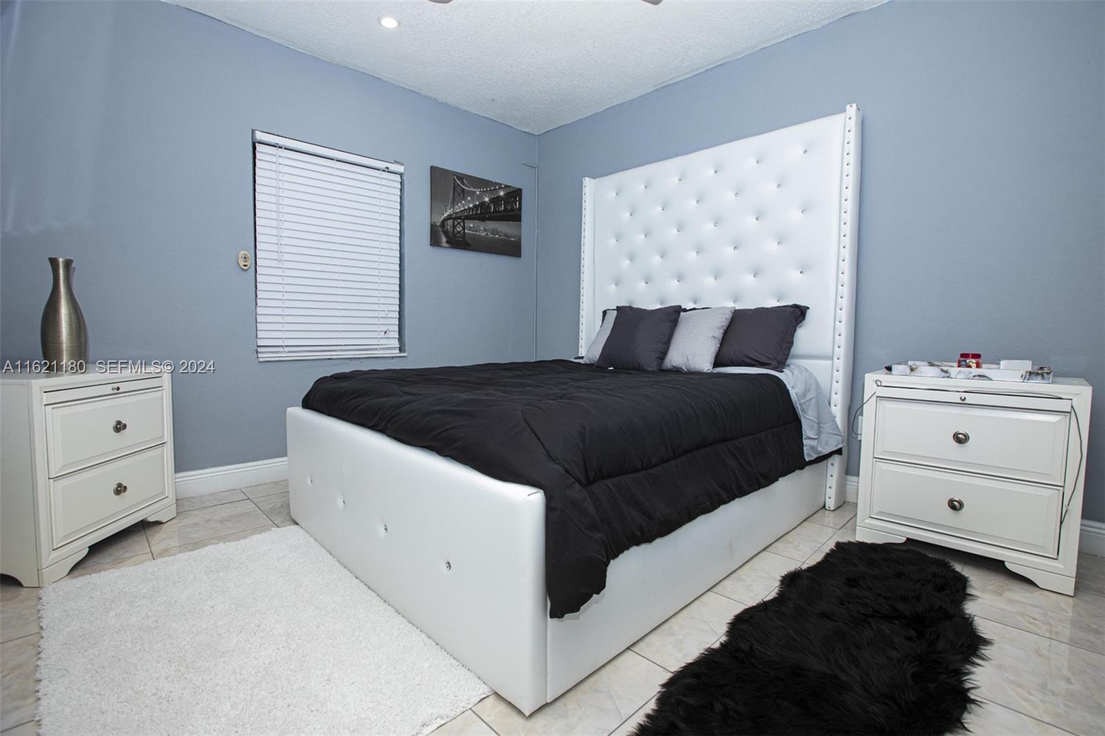 418 Northwest 47th Street Miami, FL 33127 - Photo 7 of 24 a bedroom with a bed and a window