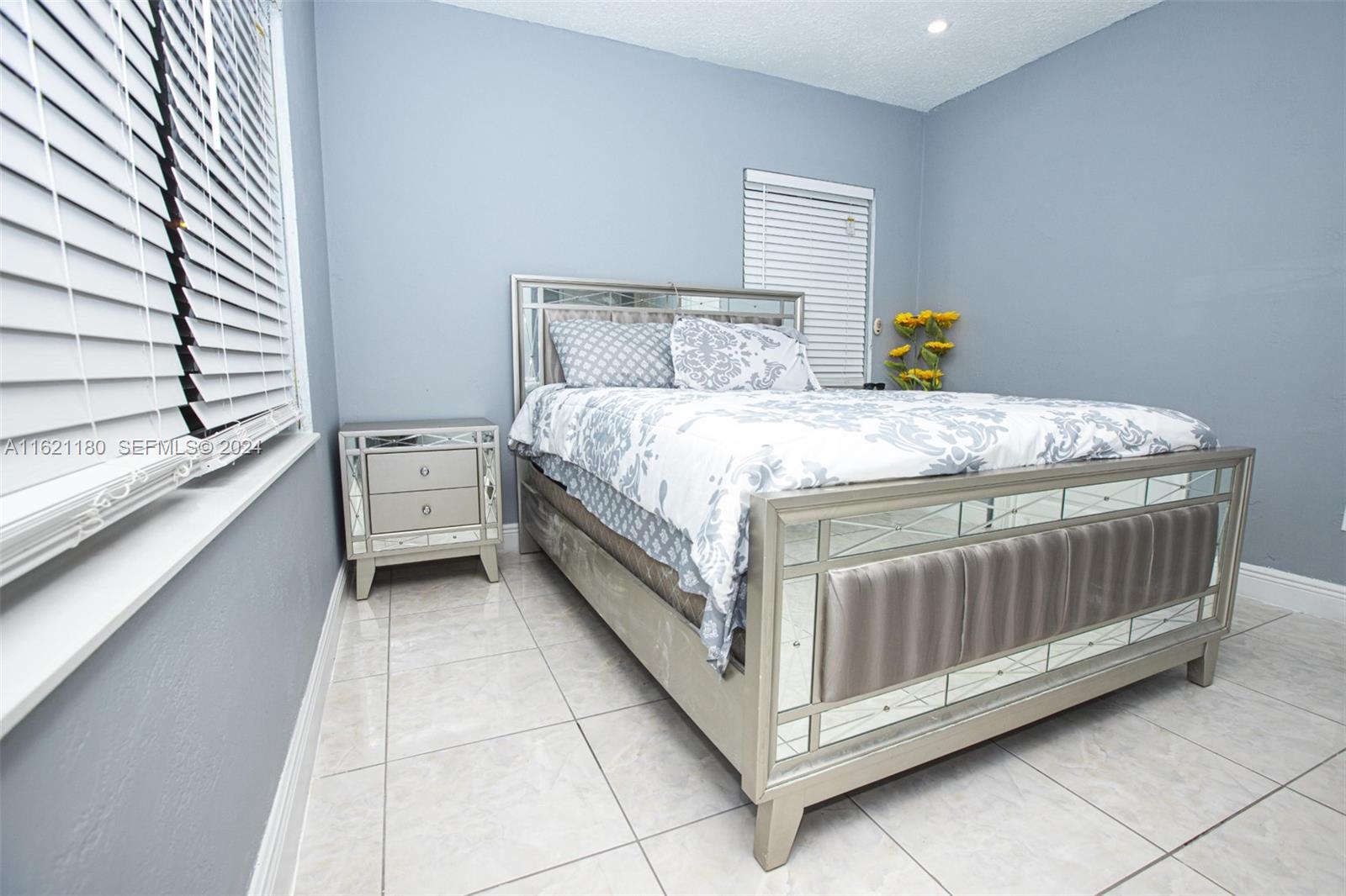 418 Northwest 47th Street Miami, FL 33127 - Photo 8 of 24 a bed sitting in a bedroom next to a window