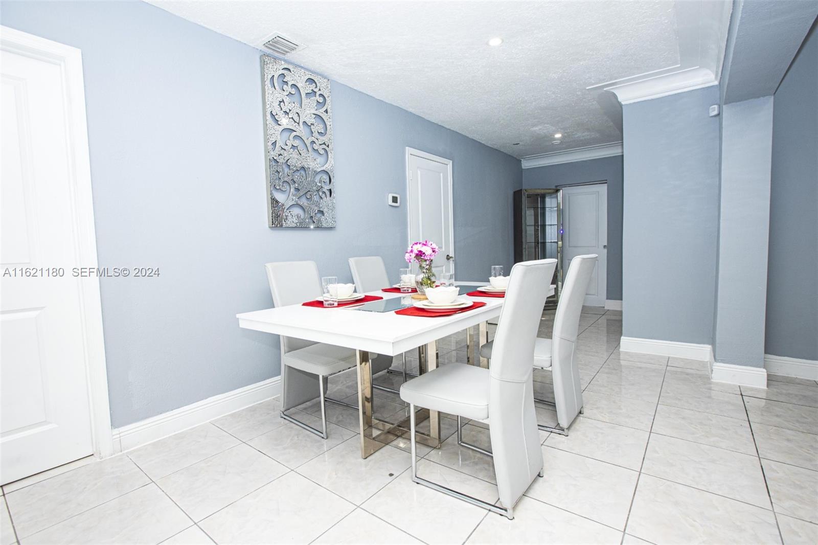 418 Northwest 47th Street Miami, FL 33127 - Photo 9 of 24 a dining room with a table and chairs