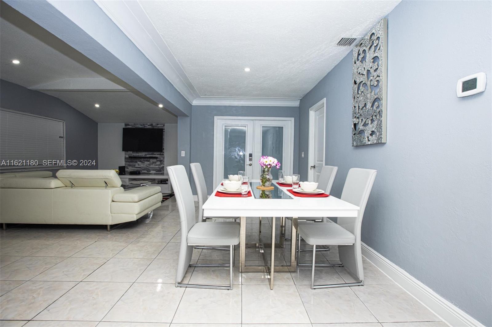 418 Northwest 47th Street Miami, FL 33127 - Photo 10 of 24 a dining room with a table and chairs