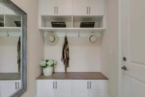 a kitchen with granite countertop white cabinets and white stainless steel appliances