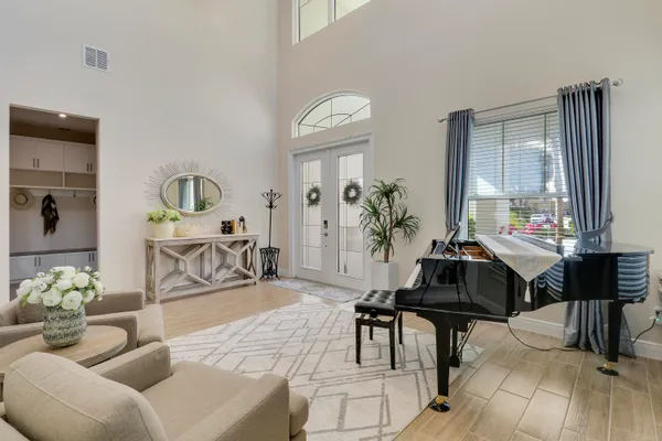 a kitchen with stainless steel appliances granite countertop a stove top oven a sink dishwasher a dining table and chairs with wooden floor