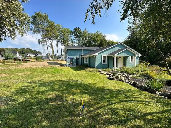 a view of a house with a yard and sitting area