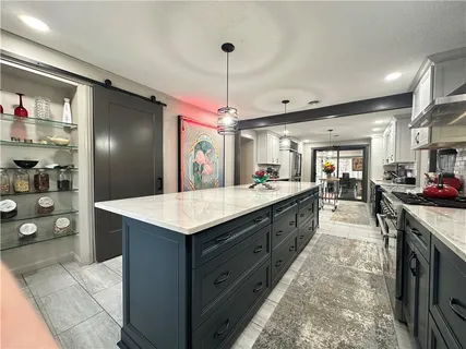 a large kitchen with granite countertop a lot of counter top space