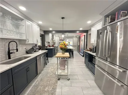 a kitchen with a refrigerator and a sink
