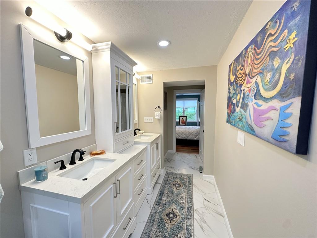 257 Stoup Road Mars, PA 16046 - Photo 27 of 50 a bathroom with a sink a mirror a vanity and a shower