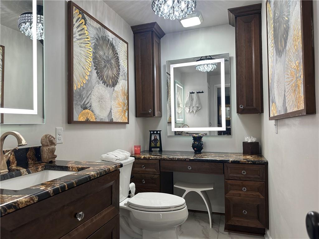 257 Stoup Road Mars, PA 16046 - Photo 31 of 50 a bathroom with a granite countertop toilet sink and mirror