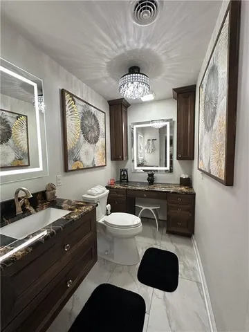 a bathroom with a sink a bathtub a mirror and vanity