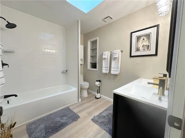 a bathroom with a tub sink and a mirror