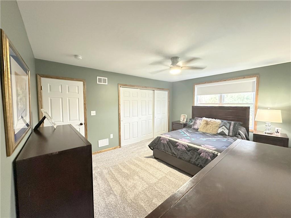 257 Stoup Road Mars, PA 16046 - Photo 39 of 50 a spacious bedroom with a large bed and a chandelier