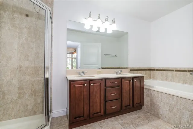 a spacious bathroom with a granite countertop sink a mirror and a