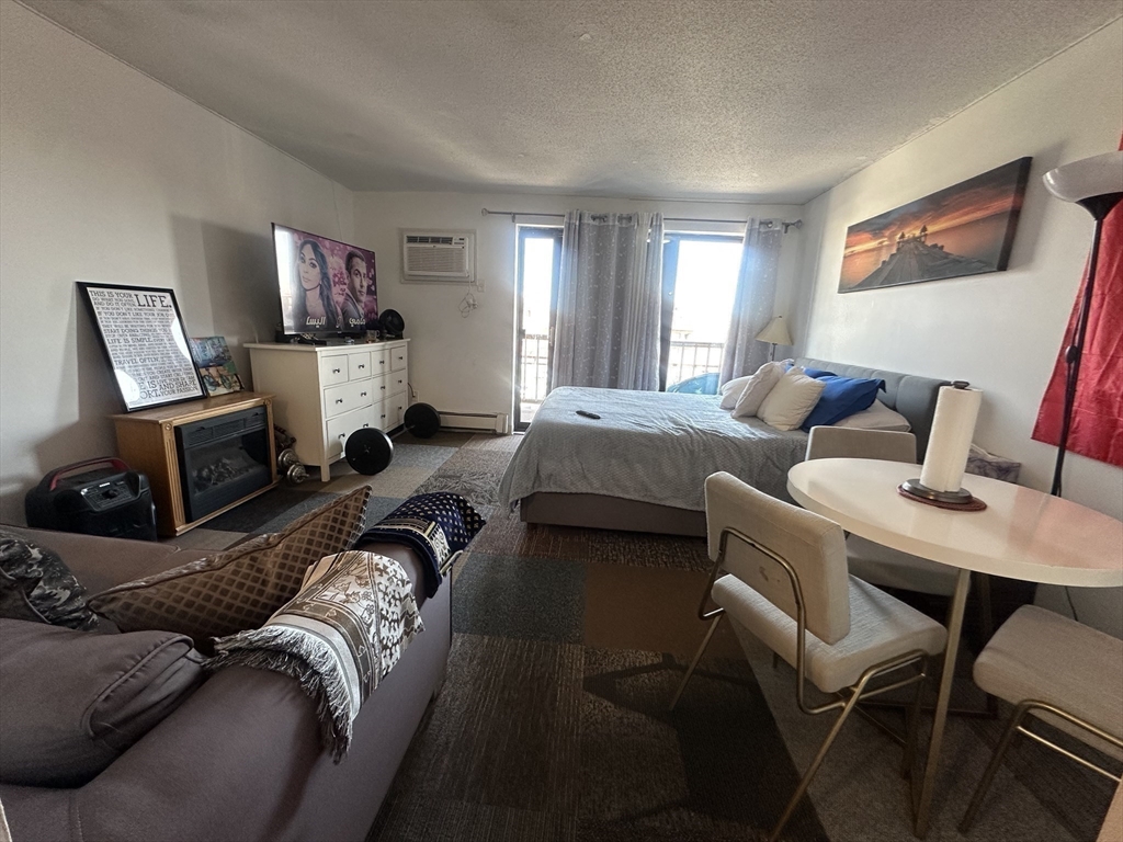 175 Ward Street, Unit 78 Revere, MA 02151 - Photo 12 of 20 a bedroom with a bed and wooden floor