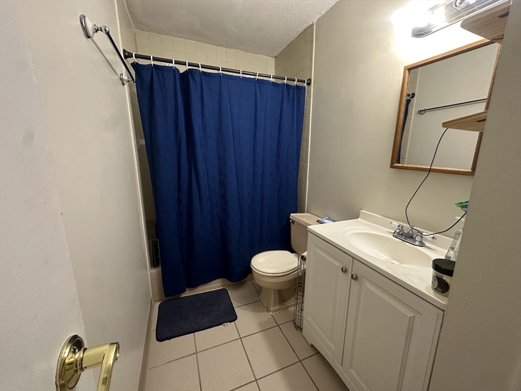 175 Ward Street, Unit 78 Revere, MA 02151 - Photo 9 of 20 a bathroom with a sink a toilet and a mirror