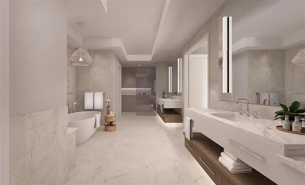 a bathroom with a double vanity sink toilet and tub