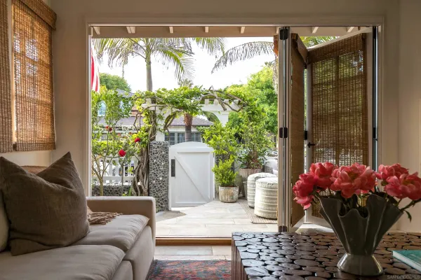a living room with furniture and a potted plant